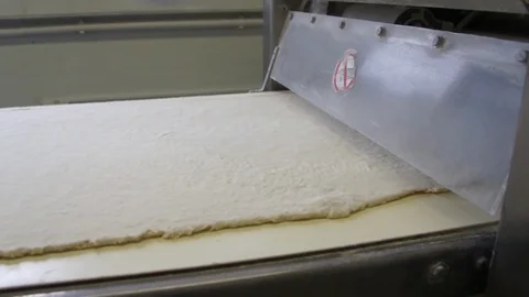 Rolled the dough on the machine and cut Stock Footage 81285395
