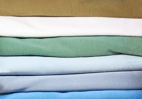 Rolled fabrics set up in stack. Stock Photos