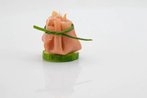 Rolled ham on a cucumber Stock Photos