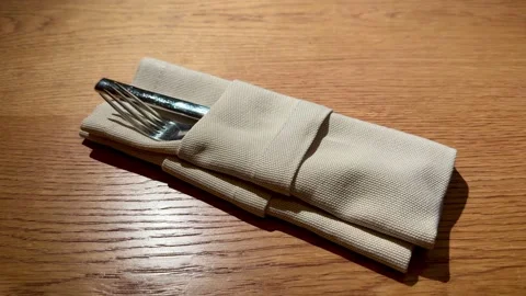 Rolled Napkin With Cutlery On Table Server Prepping Setting For Intimate Dinner Stock Footage 325213582