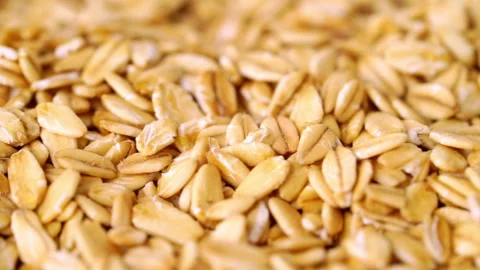 Rolled oat, oat flakes background or texture. Slow motion Stock Footage 243108613