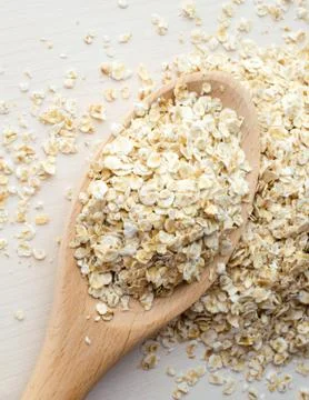 Rolled oats in a big spoon Stock Photos