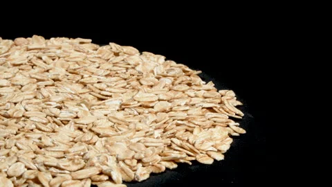 Rolled Oats on Black Background with Negative Space. Video stock 333048461