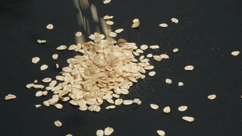 Rolled Oats Falling Slowly on Black Background Isolated. Video stock 333095723