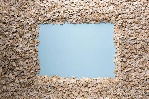 Rolled oats frame background with blue copy space Stock Photos