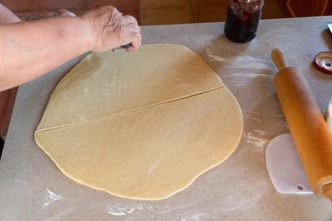 Rolled out dough on bright kitchen counter with rolling pin Stock Photos