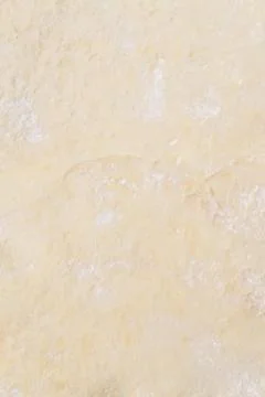 Rolled out raw dough on a table with scattered flour Stock Photos