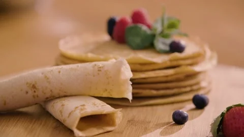 Rolled Up Pancake next to a Stack of fresh Pancakes 스톡 동영상 140780737
