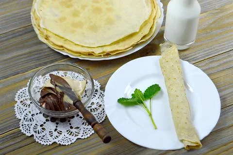 Rolled pancake on the plate Stock Photos