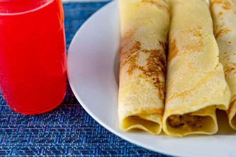 Rolled pancakes served at the table Stock Photos
