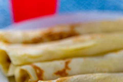 Rolled pancakes served at the table Stock Photos