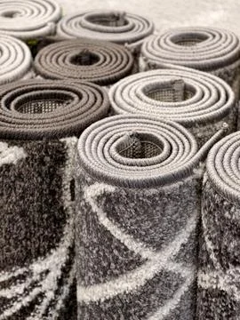 Rolled rugs featuring elegant patterns and carefully crafted woven surfaces Fotos de archivo