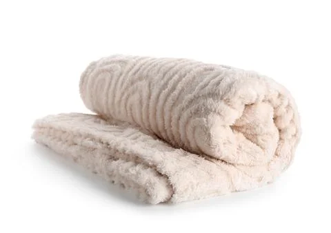 Rolled up soft beige blanket with a textured pattern, cozy home textile for c Stock Photos