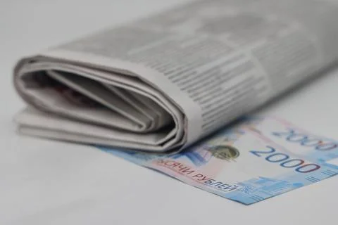 Rolled up stack of newspapers, banknotes stuck between newspapers, news, fa.. Stock Photos