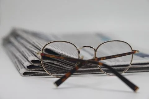 Rolled up stack of newspapers, news, corrupt journalism. Stock Photos