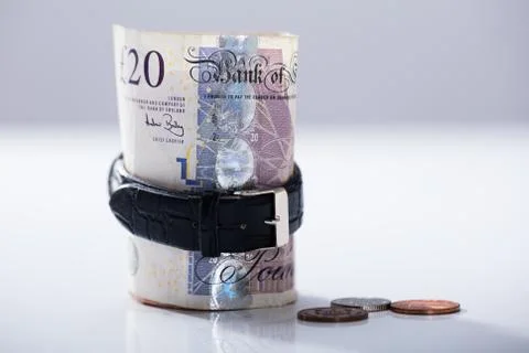 Rolled Up Twenty Pounds Currency Note Inside The Wrist Watch Stock Photos