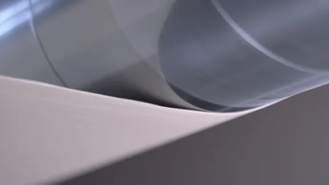 Roller acts on moving material creating flat product Video stock 303103389