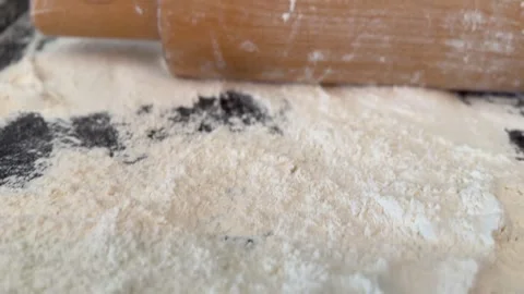 Roller and flour on dark baking surface background, ideal for culinary them.. Stock Footage 330965180