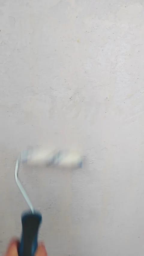 Roller applying primer on interior wall during renovation Stock Footage 335317335