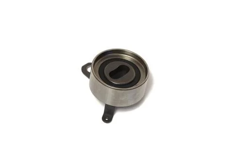 The roller in an automobile engine on a white background Stock Photos