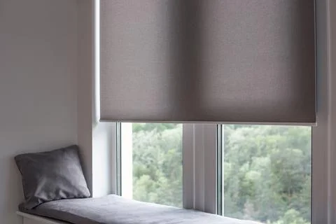 Roller blind close up on large window in the interior. Stock Photos
