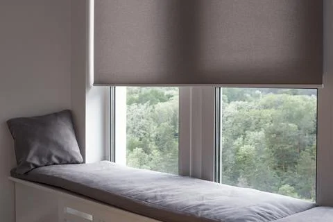 Roller blind close up on large window in the interior. Stock Photos
