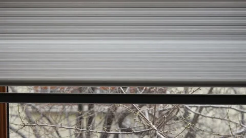 The roller blind of a window opens Video stock 172374040