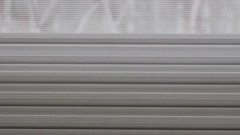 The roller blind of a window opens Stock Footage 172375752
