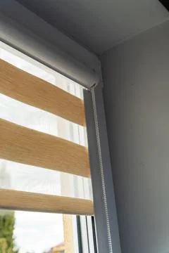 Roller blind with wooden texture designed to enhance natural light and Fotos de archivo