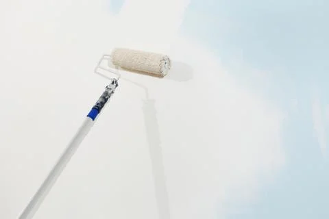 Roller brush painter isolated on white wall, painting concept Stock-Fotos