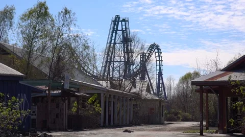 A roller coaster at an abandoned amusement park presents a spooky and haunted Stock Footage 66712799