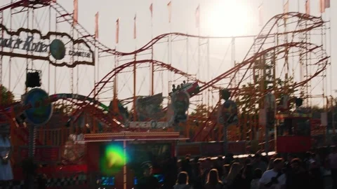 Roller coaster in an amusement park. Roller Coaster Ride on Sky Video stock 195283007