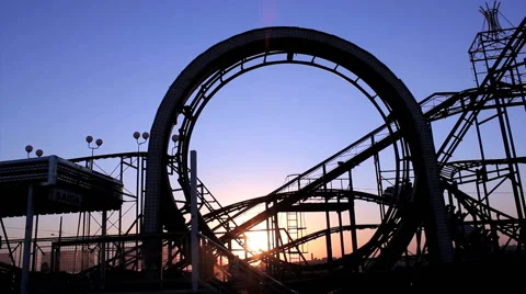 Roller coaster with blue sky. Amusement park. Sunrise view. Vídeo Stock 53299109