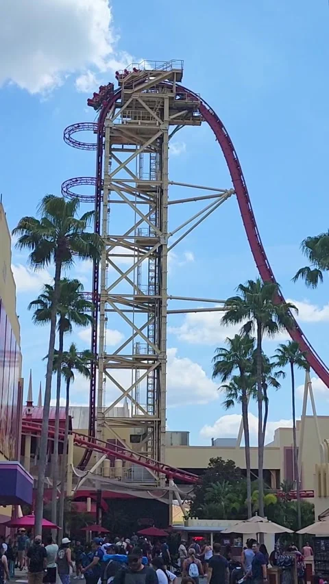 Roller coaster car reaching peak and dropping down track Universal Orlando Stock Footage 338353783