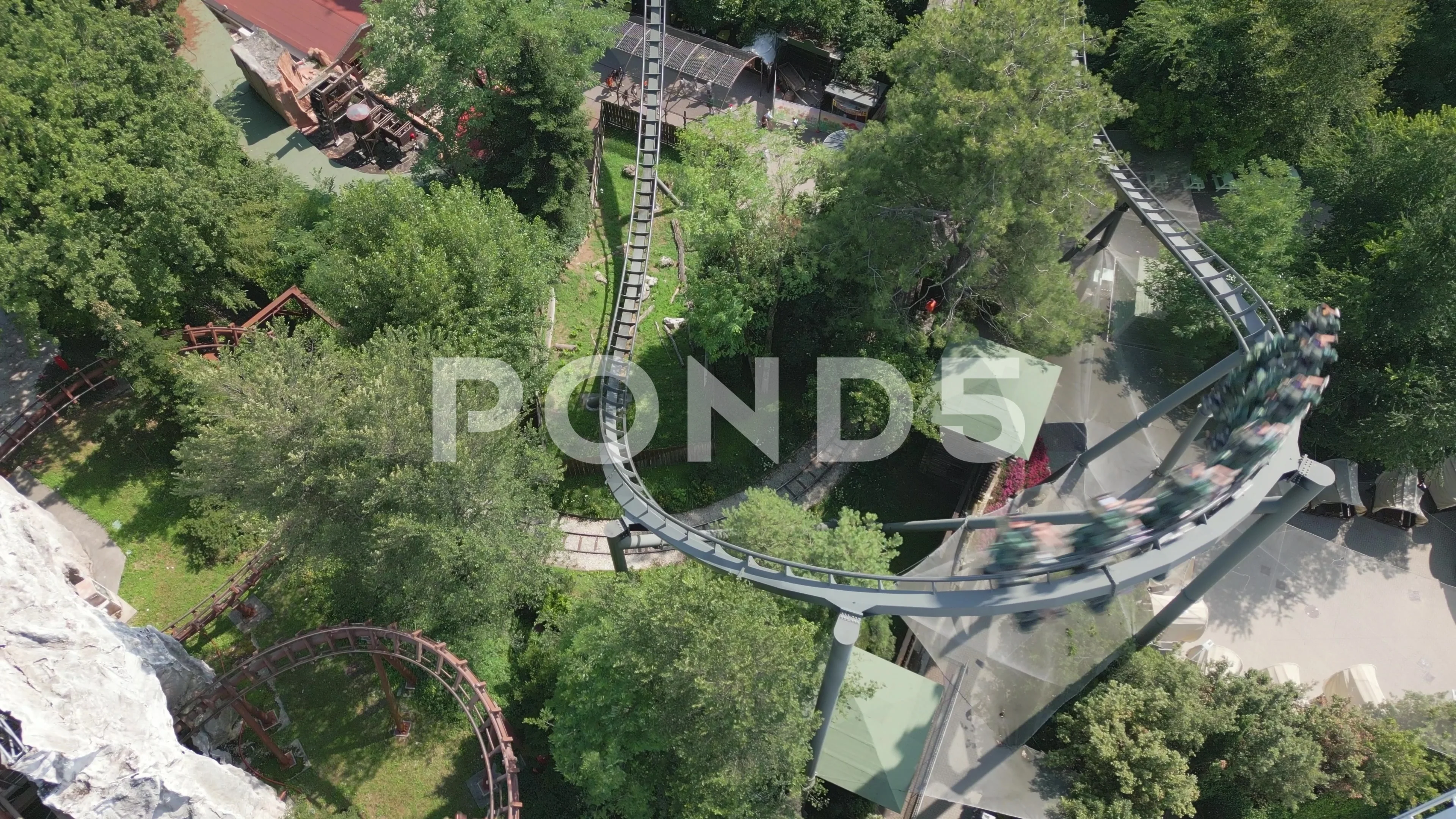 Roller coaster carriage reaches peak on track and rushes down turning hard