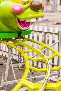 Roller coaster with caterpillar-shaped train roller coaster with green cat... Stock Photos