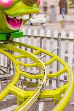 Roller coaster with caterpillar-shaped train roller coaster with green cat... Stock Photos