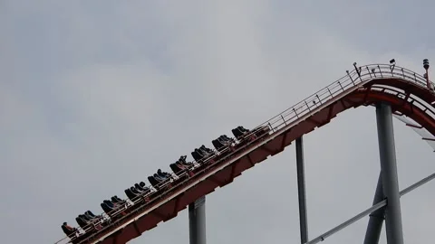 Roller Coaster Climbs High Into the Sky at Amusement Park Video stock 332380932