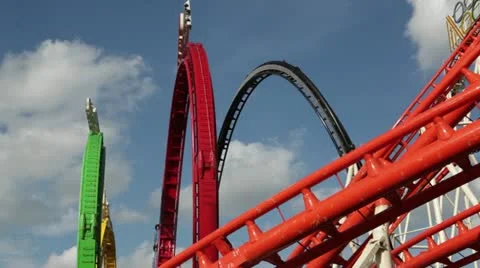 A roller coaster goes around a looping track at an amusement park. Stock Footage 22344580