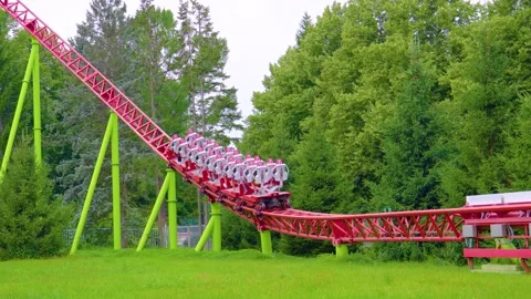Roller coaster, instant start trolleys up turn and the passing train Stock Footage 295873634
