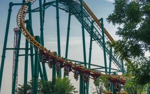 Roller coaster loop against blue sky Foto stock