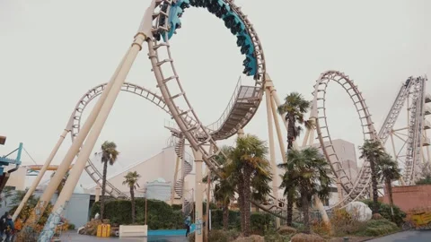 Roller Coaster Loop Against Cloudy Sky - Thrilling Amusement Ride View Stock Footage 307940240