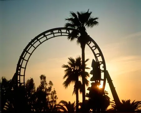 Roller coaster loop silhouetted at sunset Stock Photos
