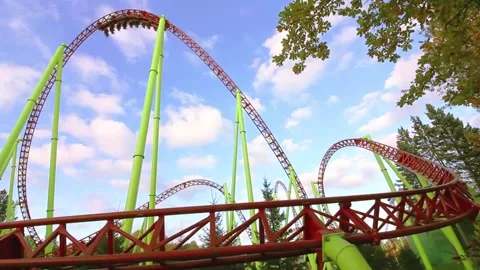 Roller Coaster Loops ride and people in carts Stock Footage 141395116