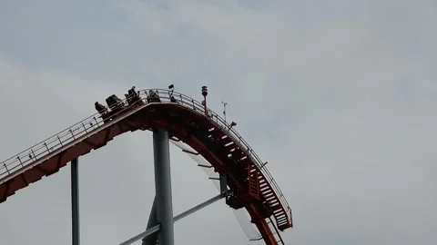 Roller Coaster Makes a Steep Drop at Amusement Park in Daytime Video stock 332380933