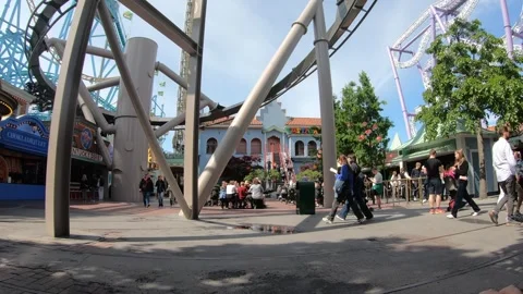 Roller coaster with people suspended below cart is passing at high speed Stock Footage 249496606