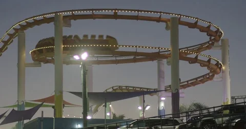 Roller Coaster Ride In Amusement Park At Night 2 Stock Footage 76485464
