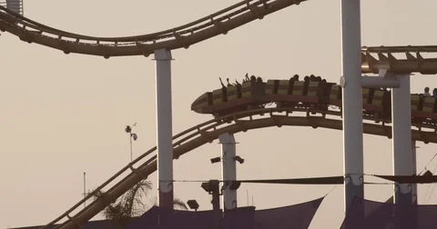 Roller Coaster Ride In Amusement Park At Sunset Stock Footage 76485660