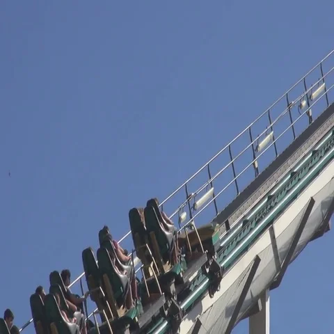 Roller coaster ride climbing with a summer day Vídeos de archivo 69734205
