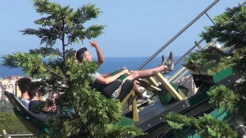 Roller coaster ride climbs with plants and blue sky background Video stock 69734376